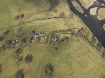 Oblique aerial view centred on the remains of rig and furrow cultivation with the East Lodge adjacent, taken from the S.