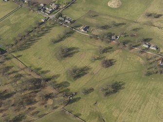 Oblique aerial view centred on the remains of rig and furrow cultivation with the village of Upsettelington adjacent, taken from the SE.