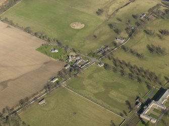 Oblique aerial view centred on the Riding Stables with the Home Farm and North Lodge adjacent, taken from the SW.