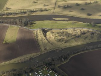 Oblique aerial view centred on the remains of the castle, taken from the SE.