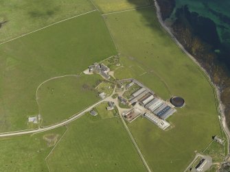 Oblique aerial view centred on the Hall of Tankerness with the farmstead and burial ground adjacent, taken from the WSW.