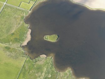Oblique aerial view centred on the remains of the possible broch on The Burrian, taken from the SW.