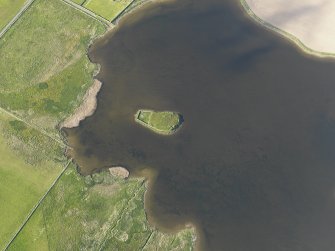 Oblique aerial view centred on the remains of the possible broch on The Burrian, taken from the SW.