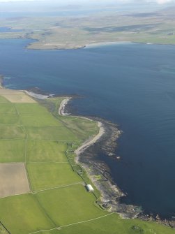 General oblique aerial view centred on Midhowe broch looking across Eynhallow Sound towards Aikerness and the Broch of Gurness, taken from the NW.