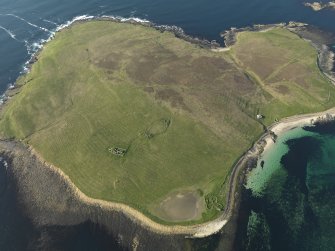 General oblique aerial view of Eynhallow with the ruins of the monastery to the left and the remains of a possible farmstead to the right, taken from the S.