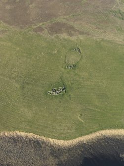 Oblique aerial view centred on the remains of Eynhallow monastery, taken from the SW.