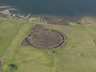 Oblique aerial view centred on the Ring of Brodgar with the cairns adjacent, taken from the SW.