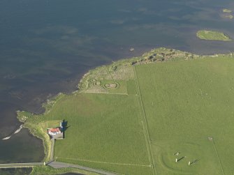 Oblique aerial view of the Stones of Stenness an the Barnhouse settlement, taken from the SW.