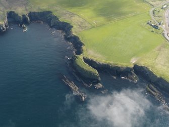 Oblique aerial view centred on Castle of Burwick promontory fort and possible monastic settlement, taken from the SW.