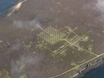 Oblique aerial view centred on the 'Z' Battery and ancilliary buildings at Golta, Flotta, taken from the NE.