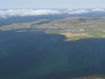 General oblique aerial view looking towards Bu Point with Stromness beyond, taken from the NE.
