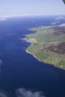 General oblique aerial view looking along the SW coast of Rousay from Corse towards Westness House, taken fromt he SE.