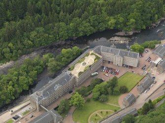 Oblique aerial view of New Lanark centred on the roof garden, taken from the ENE.