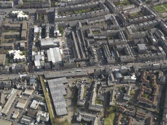 Oblique aerial view centred on part of Leith Walk, taken from the NW.