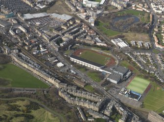 Oblique aerial view centred on the sports centre, taken from the SE.