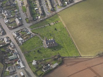 Oblique aerial view of the church with the churchyard adjacent, taken from the ESE.