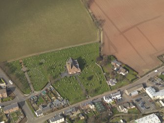 Oblique aerial view of the church with the churchyard adjacent, taken from the S.