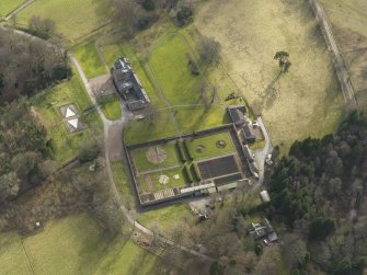 Oblique aerial view centred on the country house with the walled garden, taken from the N.
