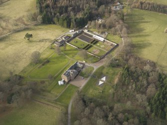 Oblique aerial view centred on the country house with the walled garden, taken from the SE.