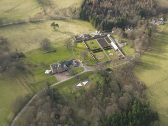 Oblique aerial view centred on the country house with the walled garden, taken from the ESE.