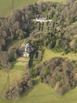 Oblique aerial view centred on the country house with the walled garden adjacent, taken from the S.