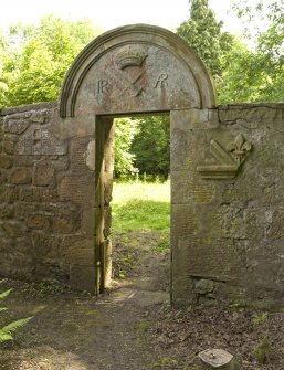 Detail of main gateway to Robertland walled garden, with round-arched pediment and carved stone fragments salvaged from old Robertland Castle.