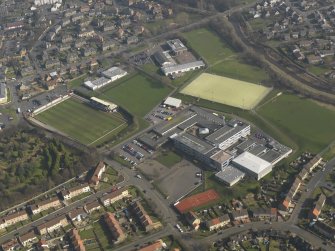 Oblique aerial view centred on Linlithgow Academy with the football ground, taken from the W.