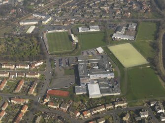 Oblique aerial view centred on Linlithgow Academy with the football ground, taken from the SW.