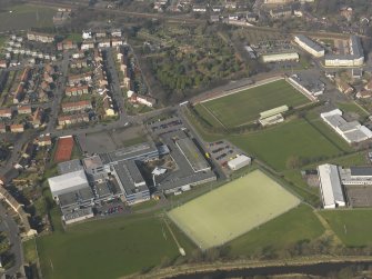 Oblique aerial view centred on Linlithgow Academy with the football ground, taken from the S.