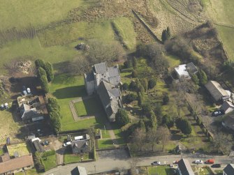 Oblique aerial view centred on the Preceptory and parish church, taken from the W.