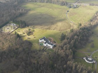 Oblique aerial view centred on the house with the garage and walled garden adjacent, taken from the SE.
