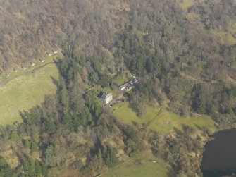 Oblique aerial view centred on the tower house/castle, taken from the SW.