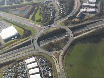 Oblique aerial view centred on the motorway interchange, taken from the E.