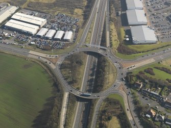 Oblique aerial view centred on the motorway interchange, taken from the NNW.