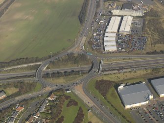 Oblique aerial view centred on the motorway interchange, taken from the WSW.