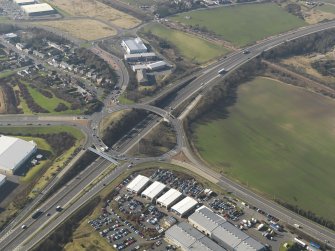 Oblique aerial view centred on the motorway interchange, taken from the ESE.