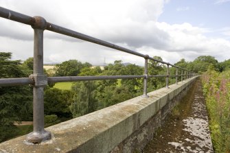 Detail of S side bridge parapet and handrail showing raised walkway.