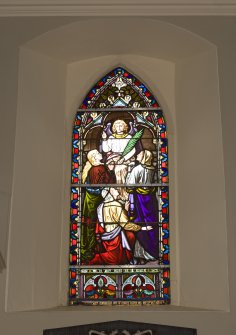 Interior. Detail of stained glass window on N wall