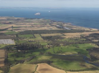 General oblique aerial view looking across Tyninghame House with the Bass Rock in the distance, taken from the SSE.