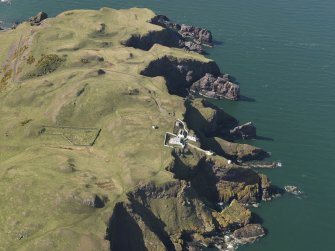 General oblique aerial view of St Abb's Head Lighthouse with the defended promontary and possible nunnery in the background, taken from the ESE.