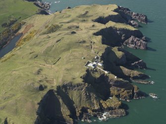 General oblique aerial view of St Abb's Head Lighthouse with the defended promontary and possible nunnery in the background, taken from the E.