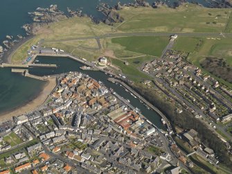 Oblique aerial view of Eyemouth centred on the harbour, taken from the WSW.