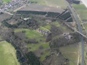 Oblique aerial view of Ayton Castle and policies, taken from the ESE.