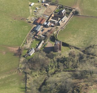 Oblique aerial view of Stoneypath Tower with farmstead adjacent, taken from the NNW.