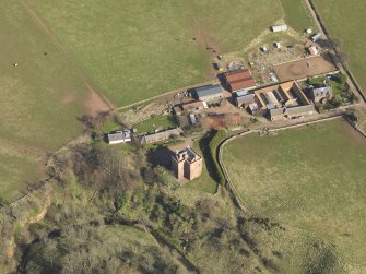 Oblique aerial view of Stoneypath Tower with farmstead adjacent, taken from the WNW.