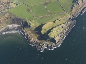 General oblique aerial view centred on the remains of the forts with the remains of the rig and furrow adjacent, taken from the W.
