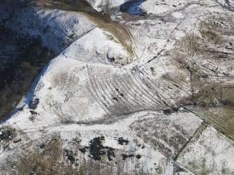 Oblique aerial view centred on the remains of the rig and furrow, taken from the W.