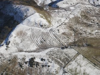 Oblique aerial view centred on the remains of the rig and furrow, taken from the W.