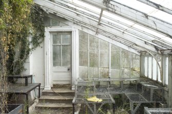 Interior. W range, view of E end wall and doorway