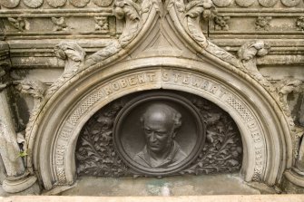 Detail of bronze commemorative plaque with ogee-arched stone surround on SSW face of Stewart Memorial Fountain, Kelvingrove Park, Glasgow